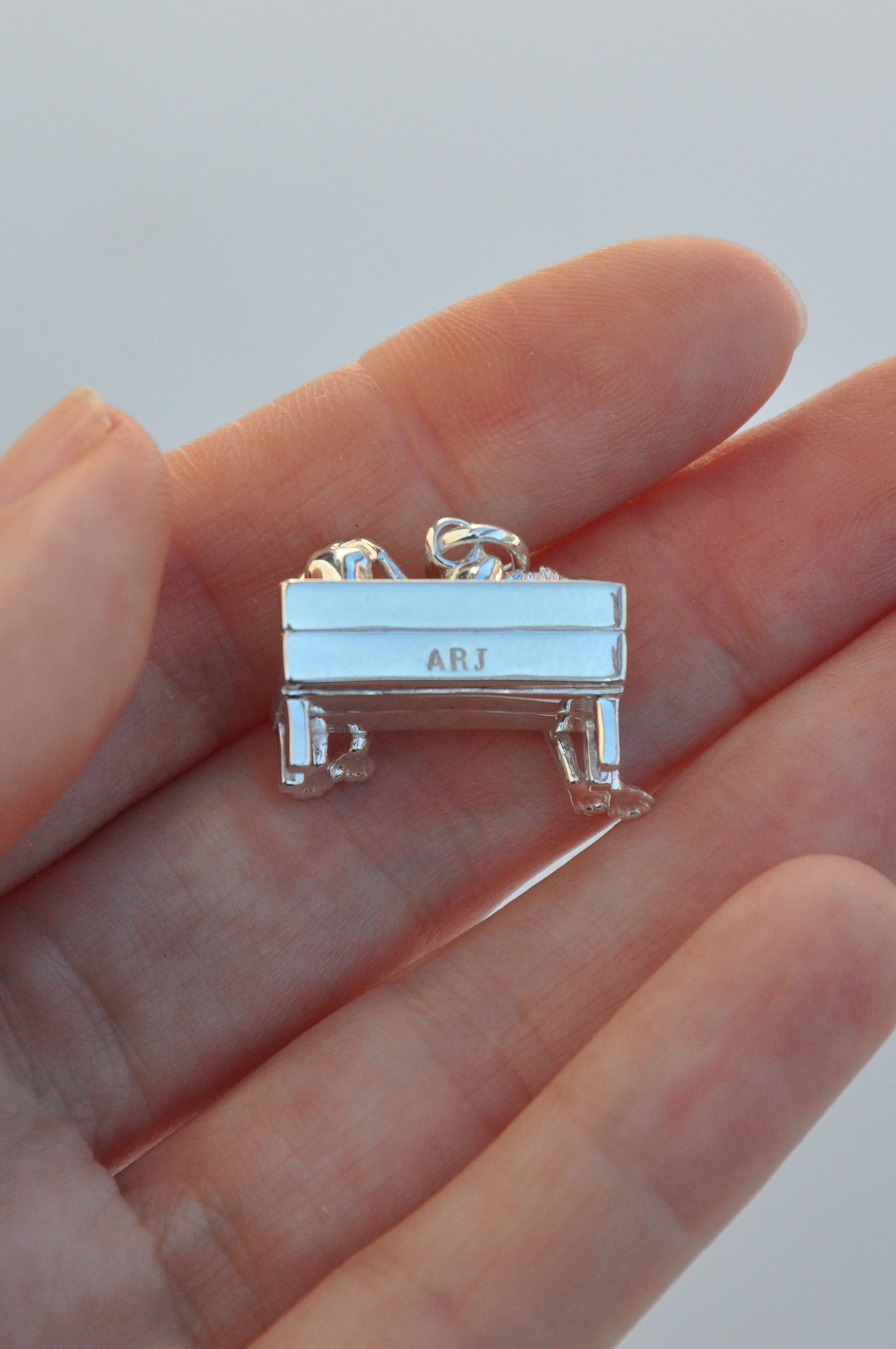 Miniature piano charm engraved with ARJ, crafted in silver as part of the Stargazer Frogs pendant collection.