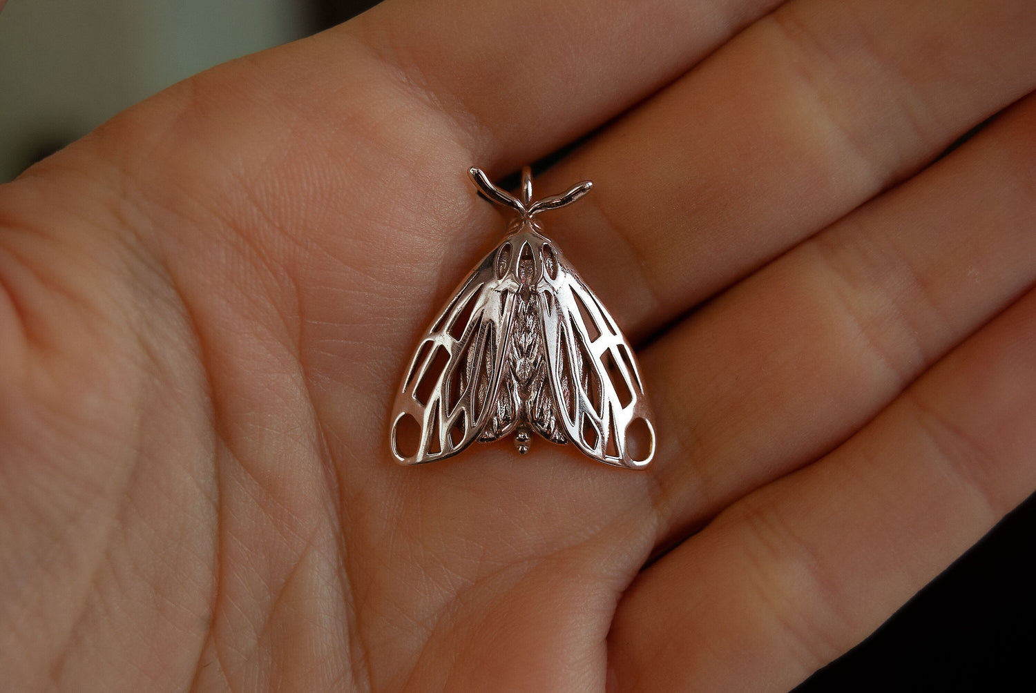Handcrafted silver Tiger Moth pendant by Anna Reikher, featuring intricate wing detailing and nature-inspired design.