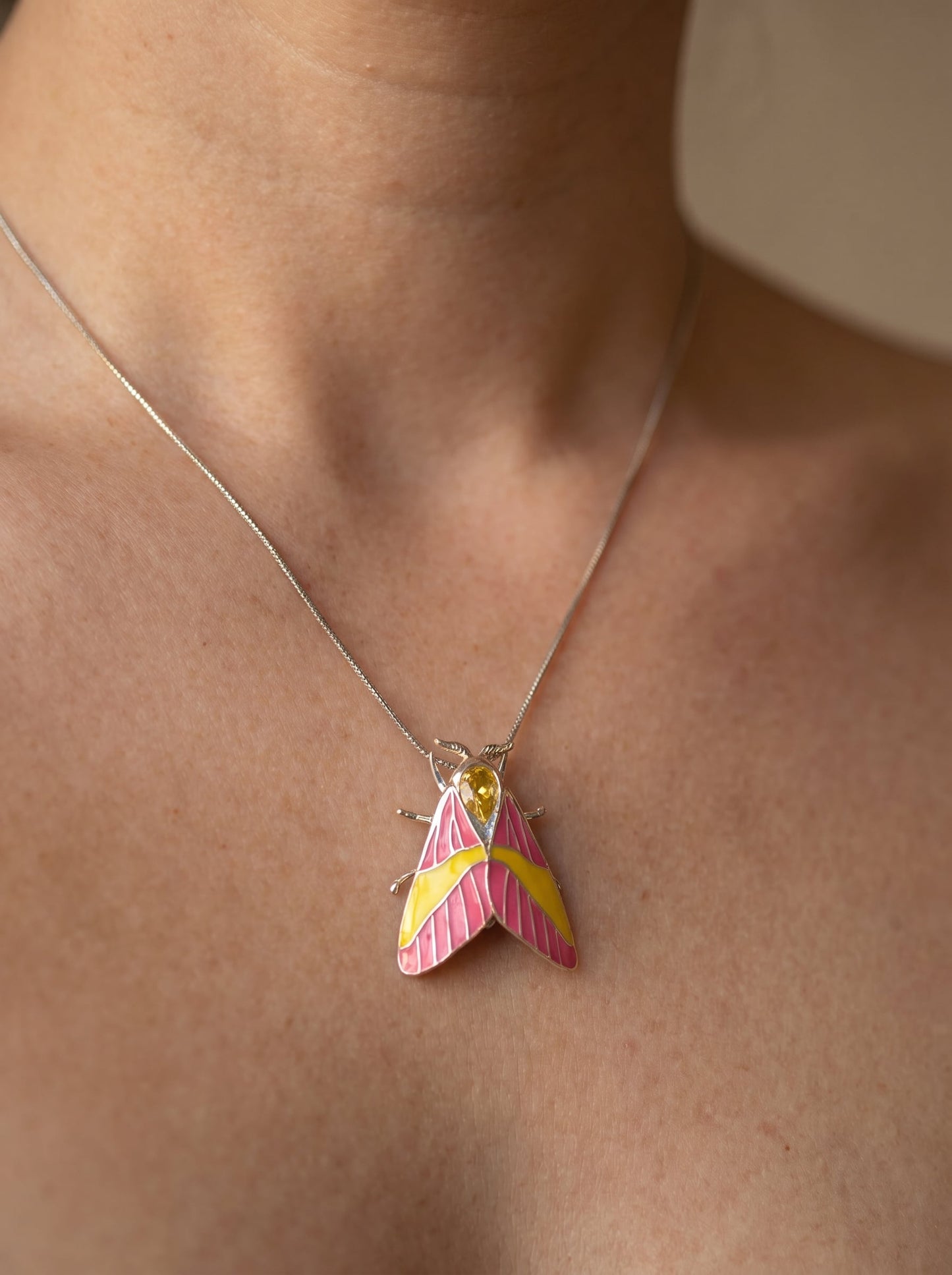 Rosy Maple Moth Pendant – Enamel Wings, Blue Gem Eyes & Yellow Crystal Accent