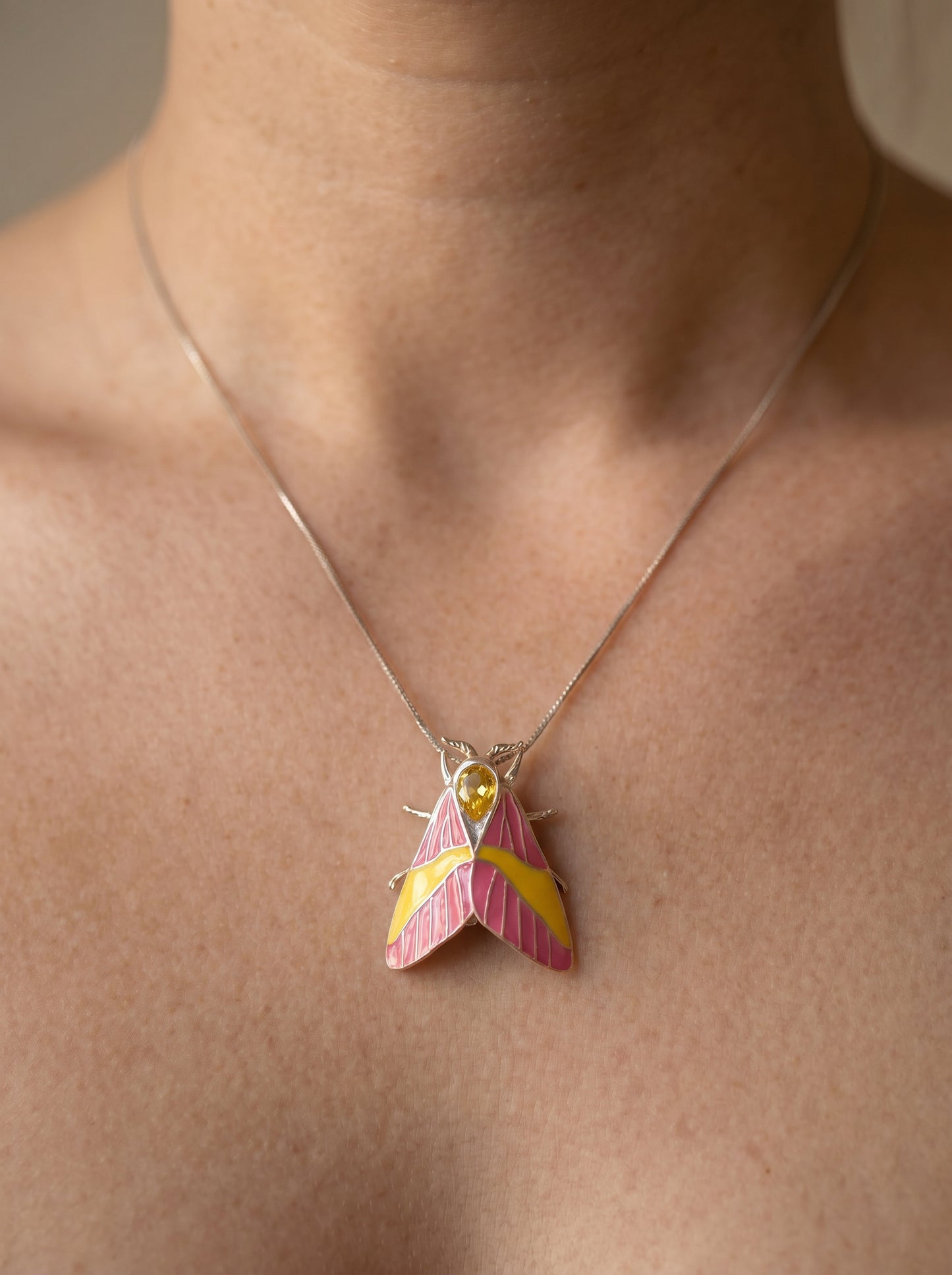 Rosy Maple Moth Pendant – Enamel Wings, Blue Gem Eyes & Yellow Crystal Accent