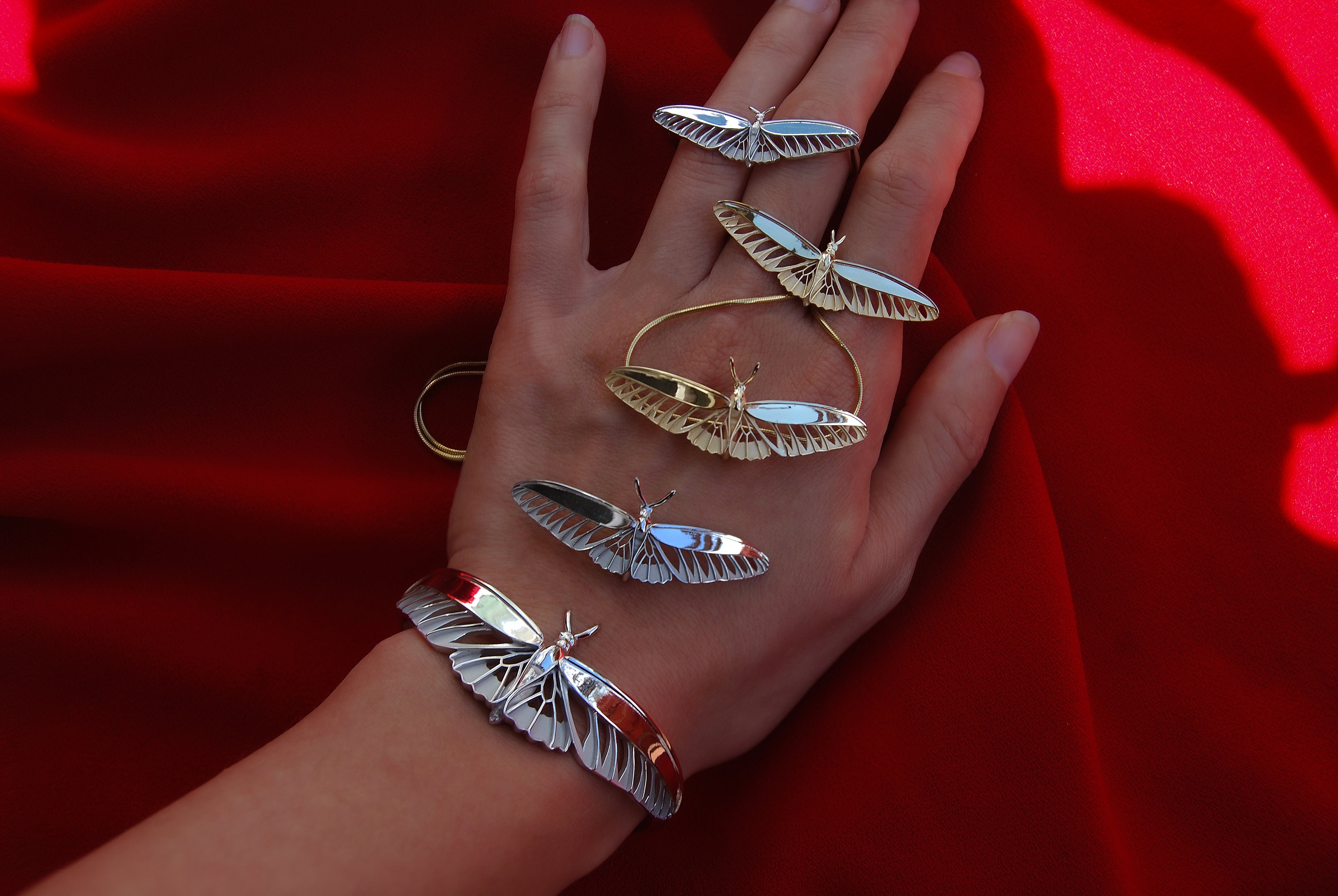 Luxury butterfly jewelry collection featuring modern birdwing-inspired pendants, bracelets, and rings by Anna Reikher