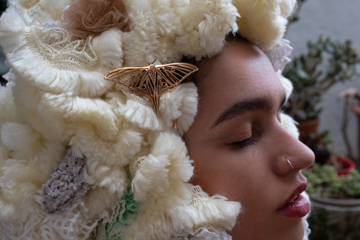 Bronze Luna Moth hair comb styled on a fantasy costume hat, set in a whimsical woodland scene with ethereal lighting and nature-inspired details.