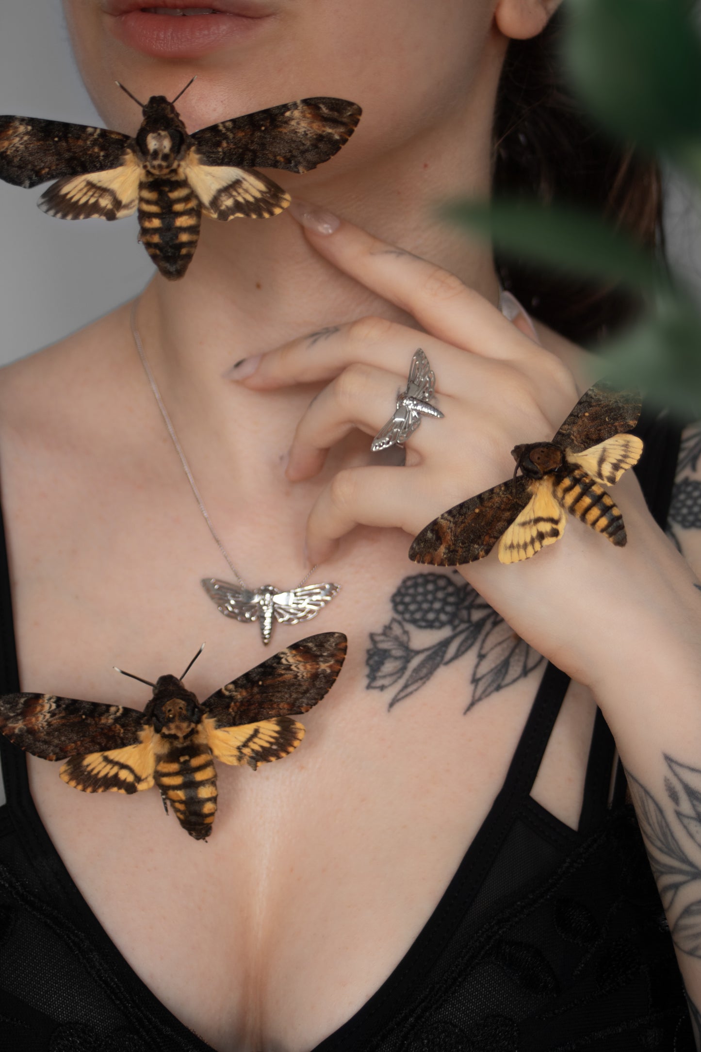 Model wearing the Death’s-head Hawk Moth pendant with matching gothic jewelry, showcasing coordinated style.