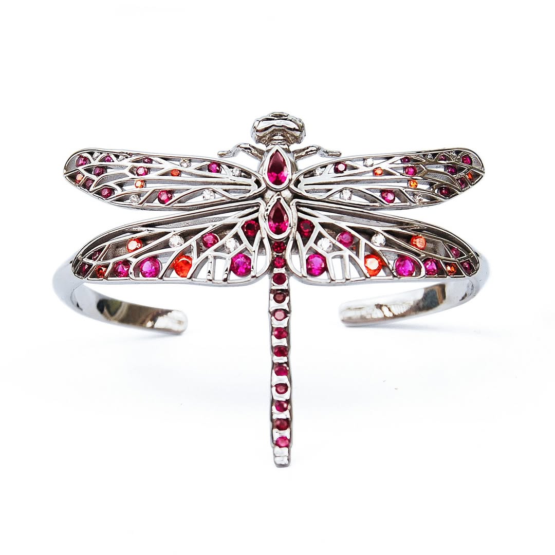 Front view of sterling silver dragonfly jewelry with red, pink, orange, and white zirconia stones on white background