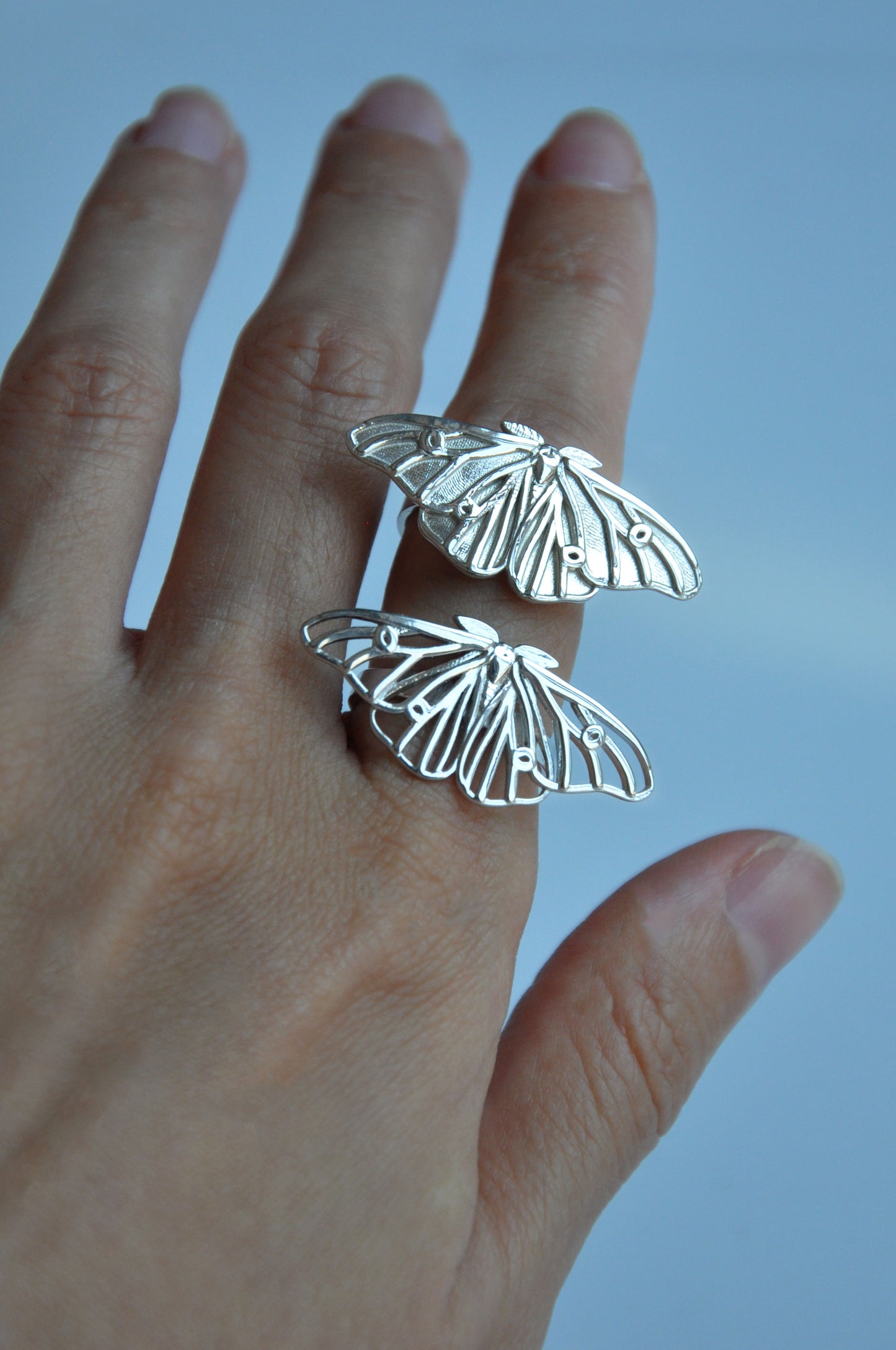 Close-up of ghostly silk moth ring showing fine wing details and sterling silver craftsmanship
