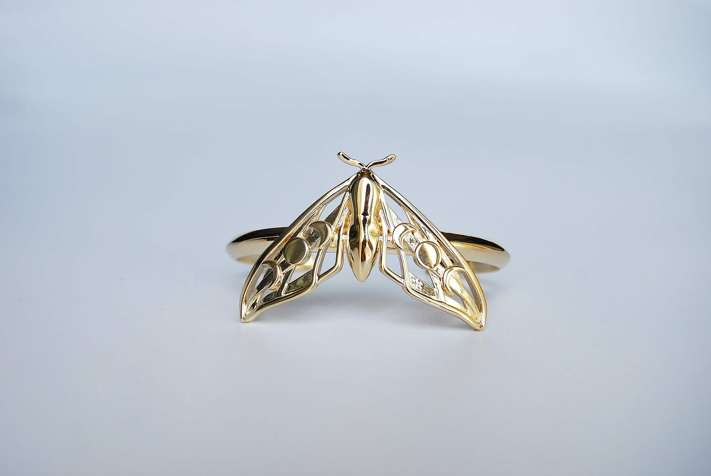 Alternate view of Hawk Moth Bracelet in 14K gold plated finish on white background, emphasizing handcrafted celestial design.