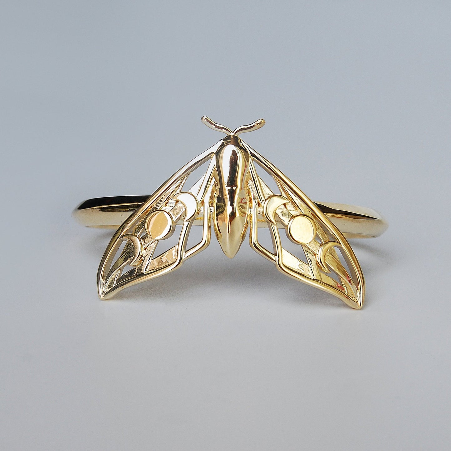 Celestial Hawk Moth Bracelet in 14K gold plated finish on white background, featuring moon phase cut-out design.