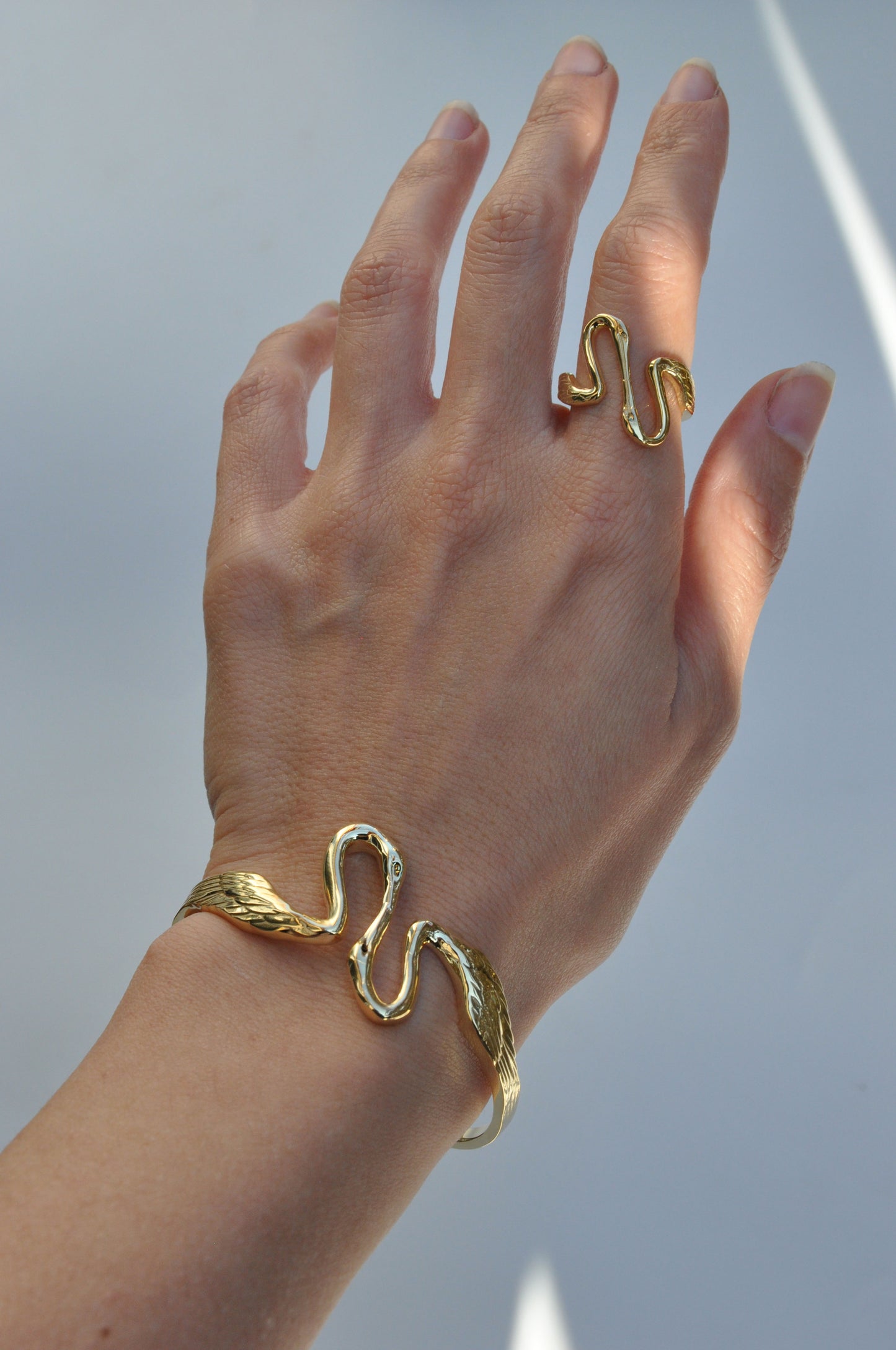 Heron Kiss Ring worn on hand, highlighting open silhouette and sculptural balance between the two herons.