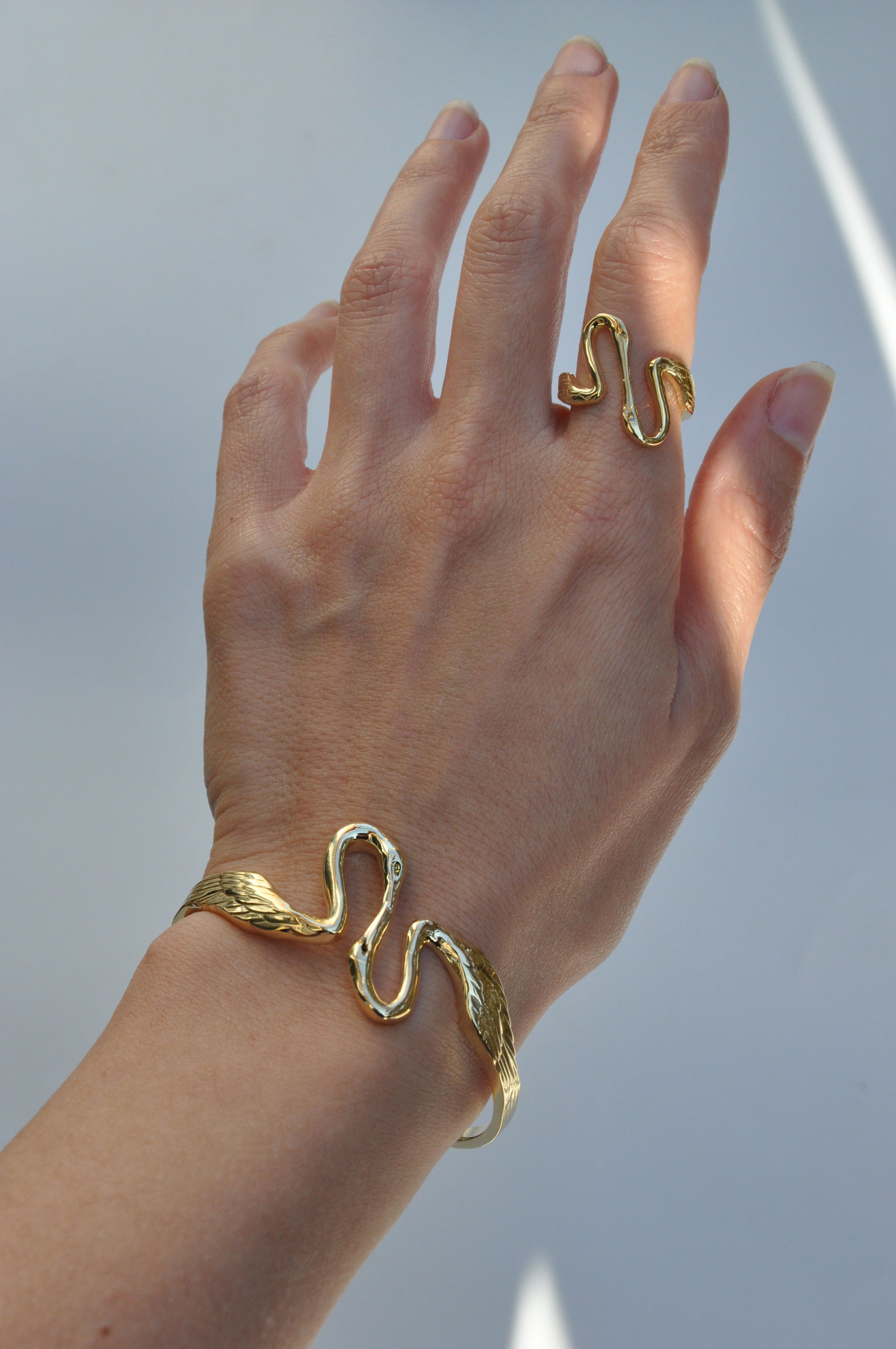 Heron Kiss Ring worn on hand, highlighting open silhouette and sculptural balance between the two herons.