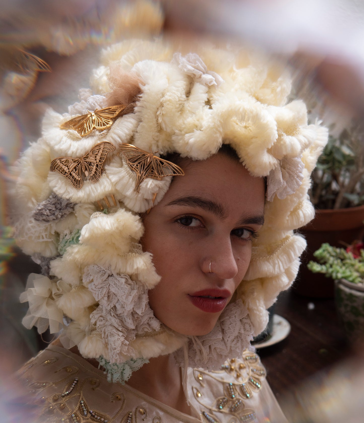 Close-up view of Bronze Luna Moth, Atlas Moth, and 14k gold plated Monarch Butterfly hair combs arranged together, showcasing intricate insect-inspired jewelry details in a fantasy woodland setting.