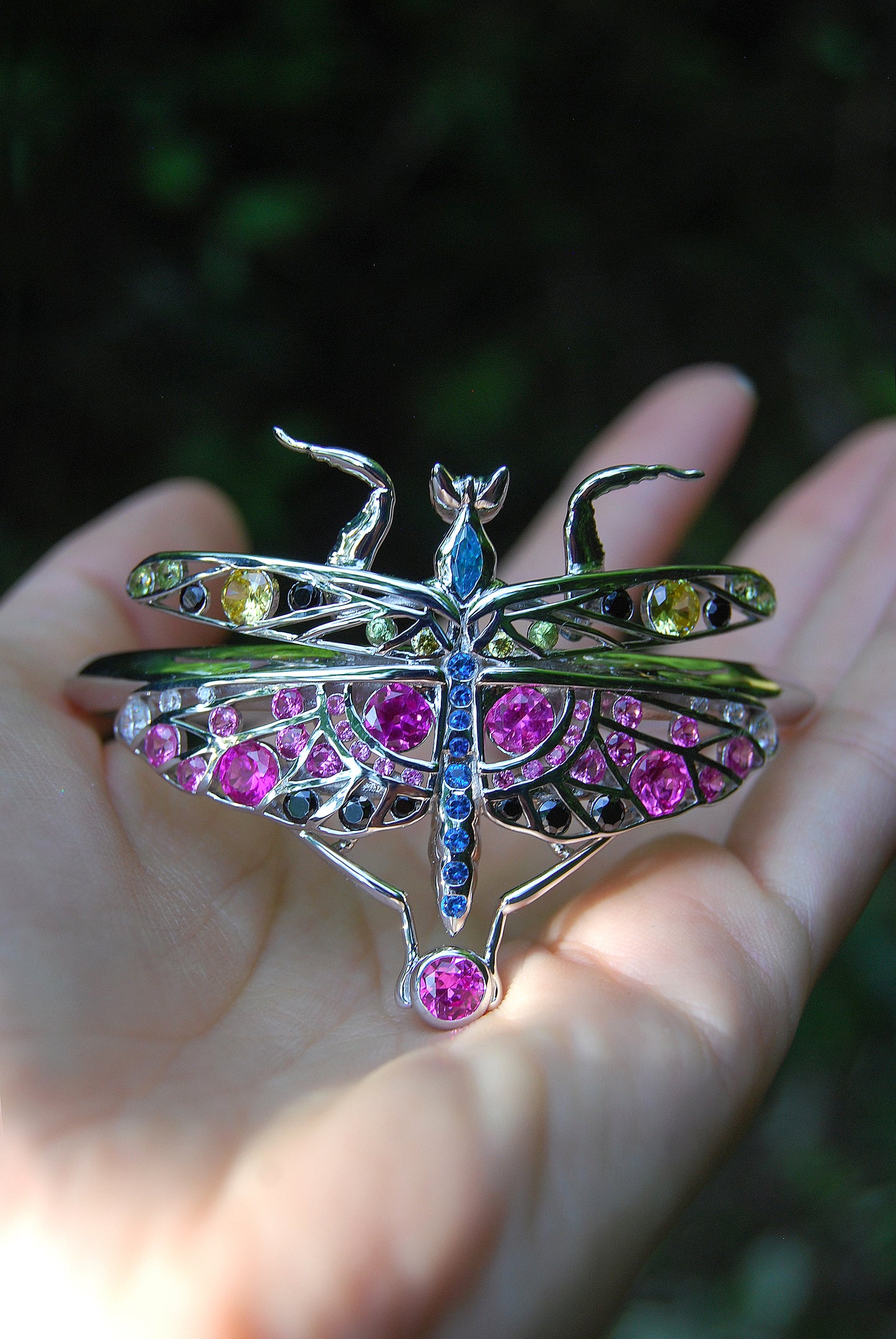 Macro shot of sterling silver mantis bracelet showcasing enamel colors and zirconia stones with fine handcrafted detailing