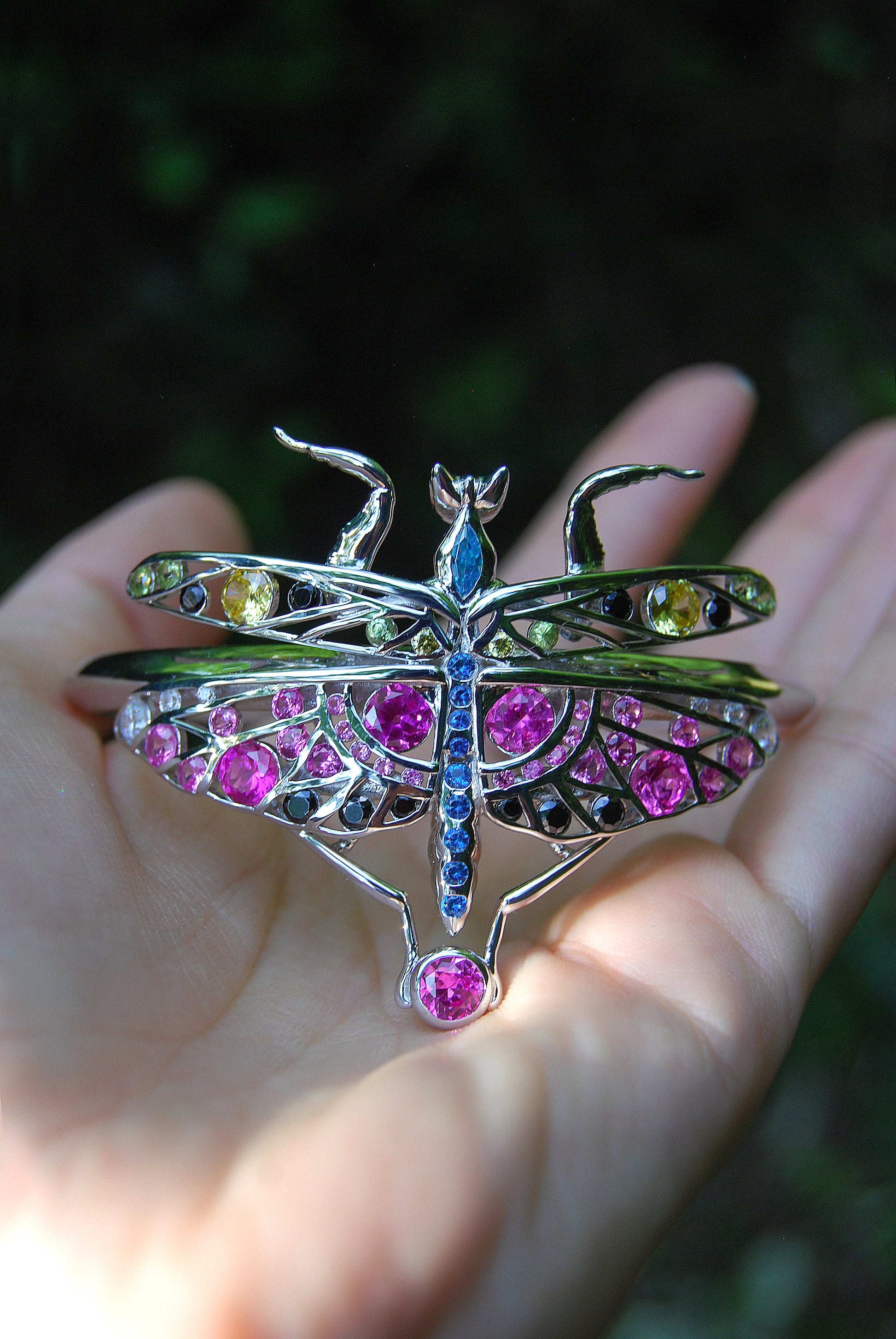 Macro shot of sterling silver mantis bracelet showcasing enamel colors and zirconia stones with fine handcrafted detailing