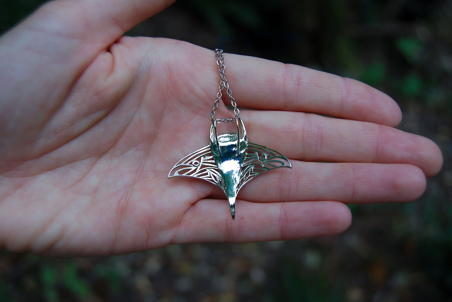 Back of manta ray pendant showing polished finish and handcrafted detailing.