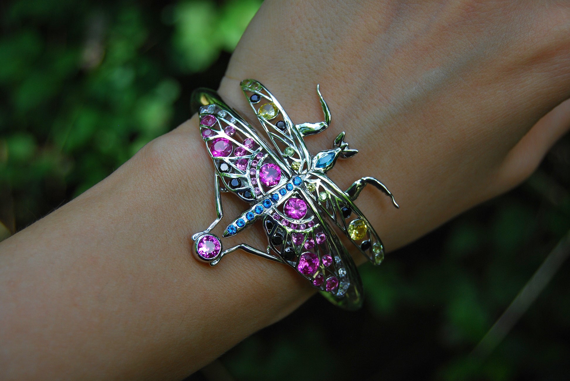 Detailed close-up of sterling silver praying mantis jewelry with enamel and zirconia stones highlighting craftsmanship and texture