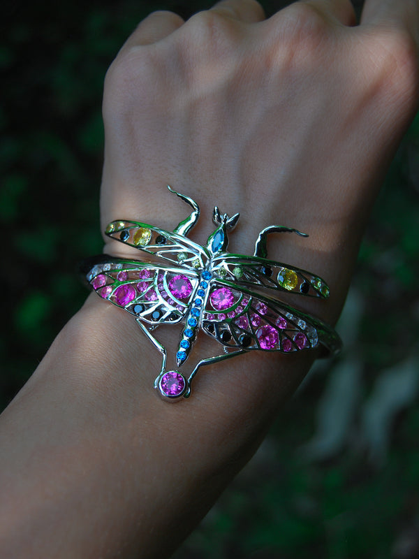 Front view of sterling silver mantis bracelet and pendant with enamel and zirconia stones worn on hand