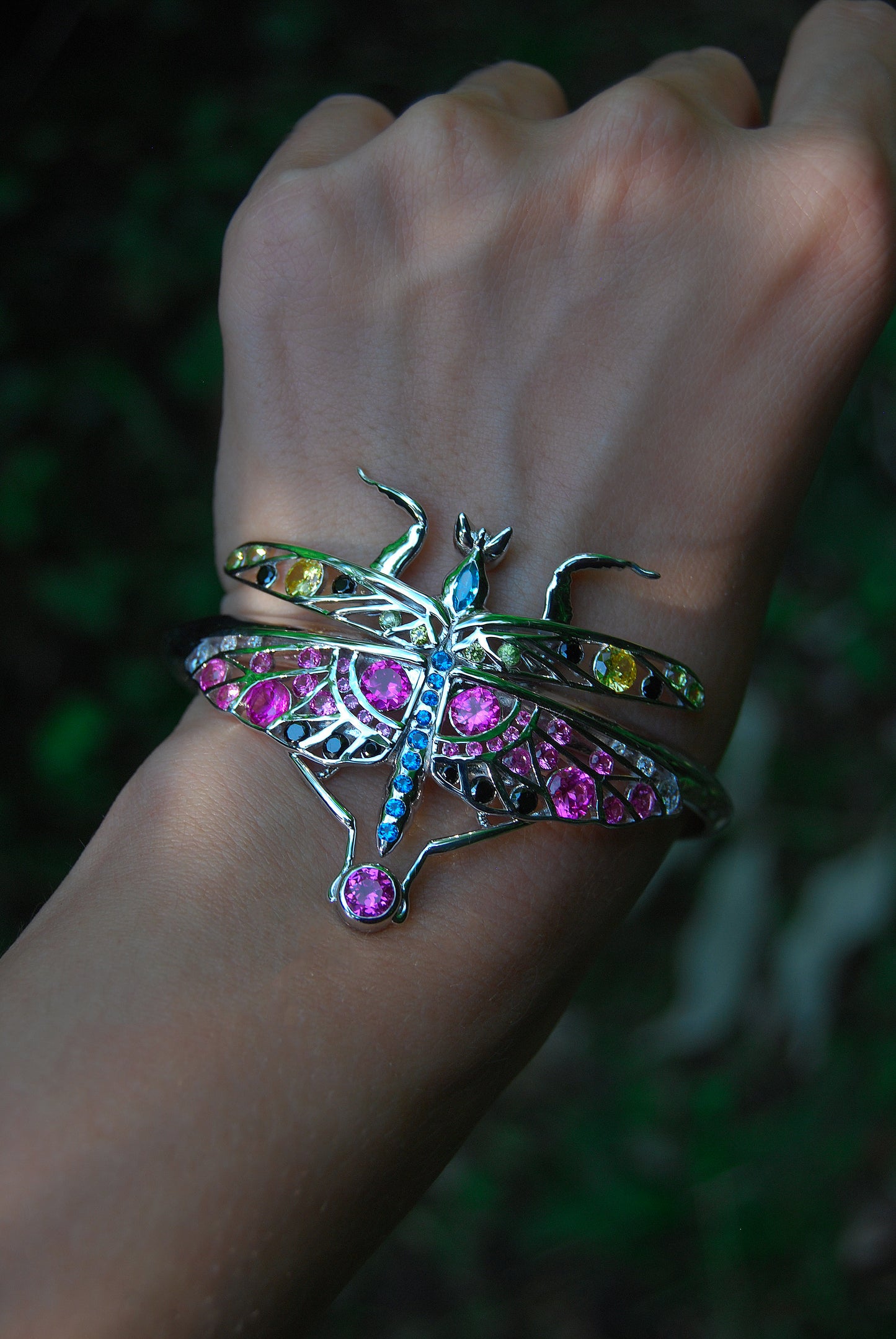Front view of sterling silver mantis bracelet and pendant with enamel and zirconia stones worn on hand