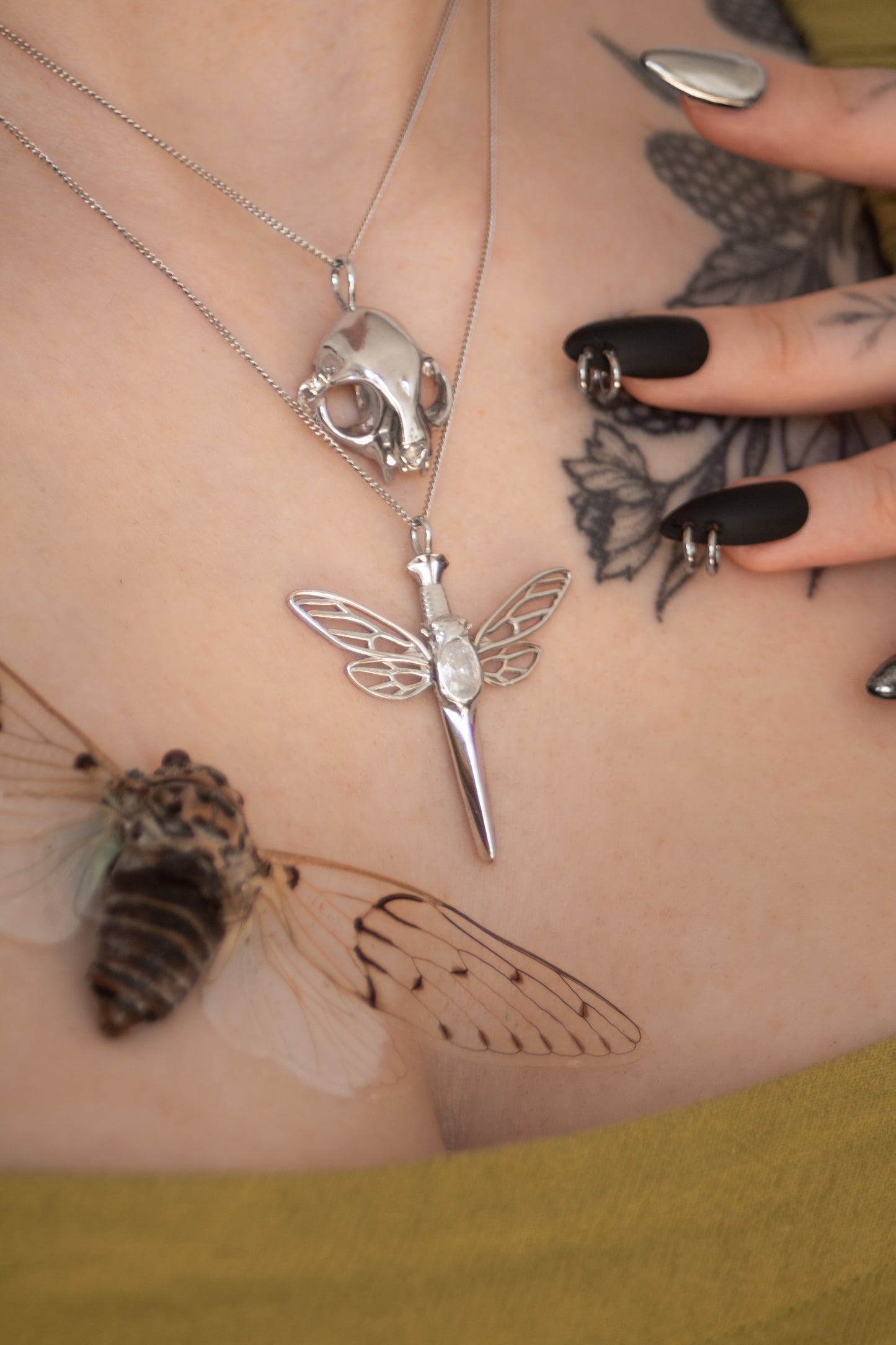 Model wearing the silver feline skull pendant paired with complementary jewelry pieces, showcasing an edgy, coordinated look.