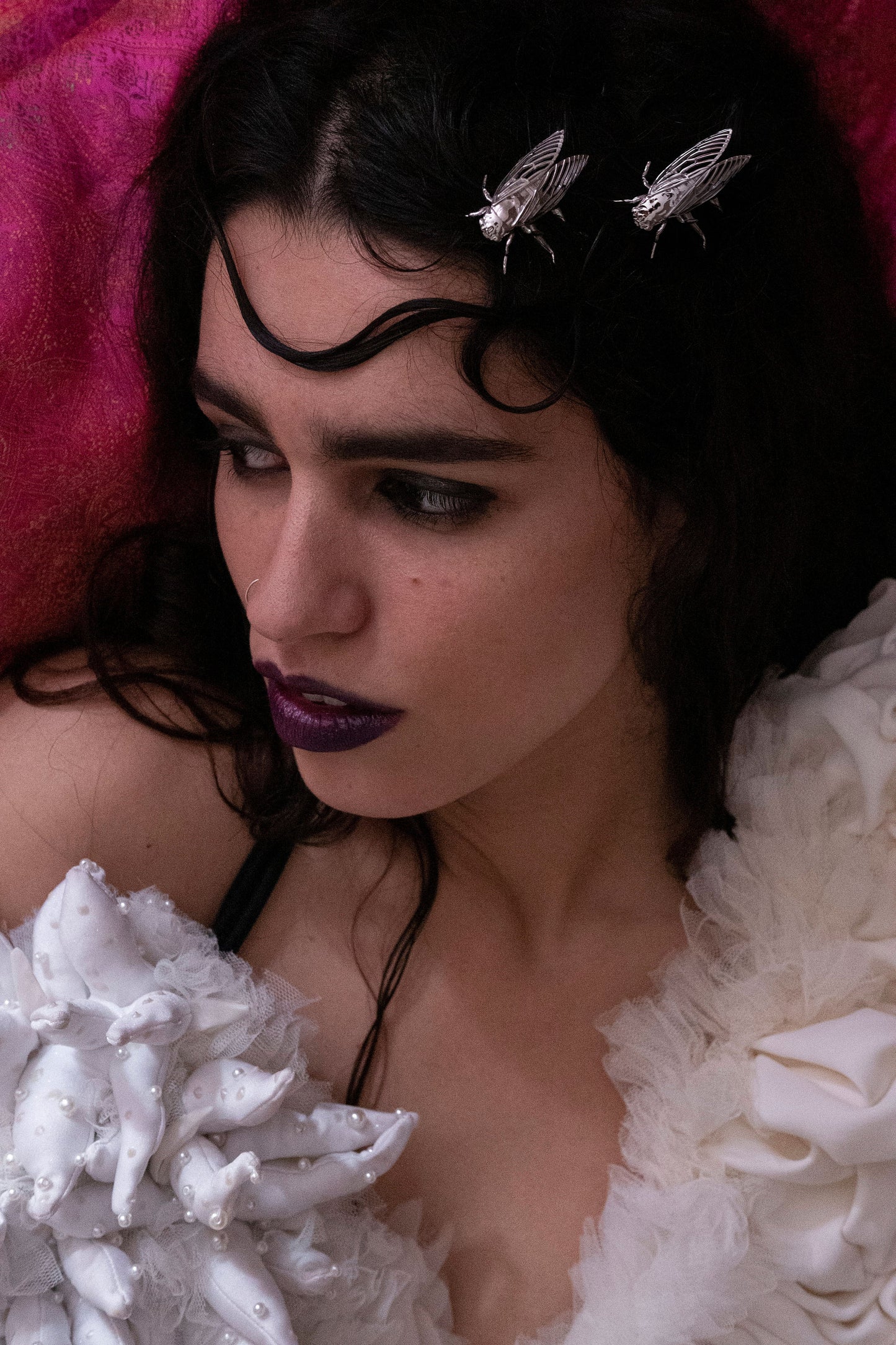 Fashion model showcasing silver cicada hair pins styled in an elegant updo, highlighting the intricate insect design and metallic shimmer of nature-inspired jewelry.