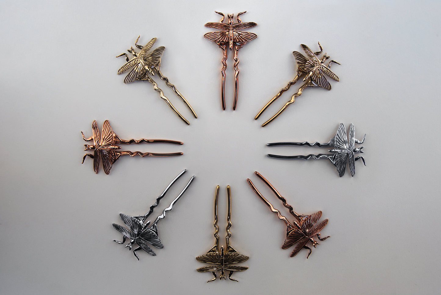 Orchid Mantis hairpins arranged in a circle, showing silver, gold, and rose gold finishes.