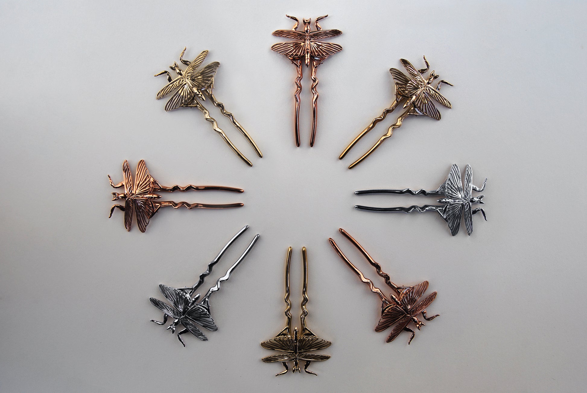 Orchid Mantis hairpins arranged in a circle, showing silver, gold, and rose gold finishes.