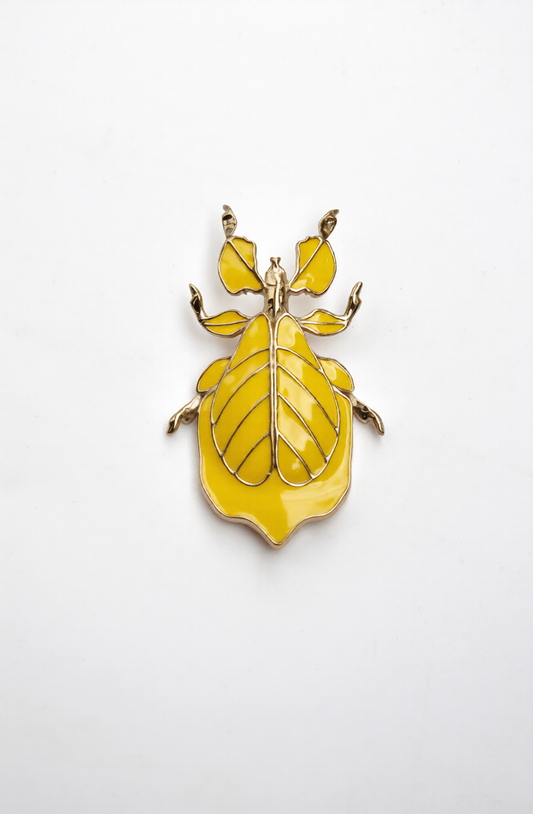 Phylliidae leaf insect pendant in warm yellow enamel with mirror-polished 14k gold-plated finish, sculptural botanical jewelry inspired by walking-leaf insect camouflage