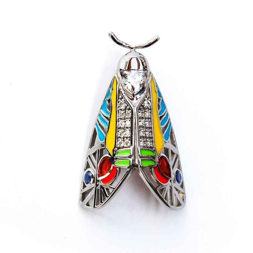 Picasso Moth pendant on white background featuring colorful enamel detailing and vibrant zirconia stones