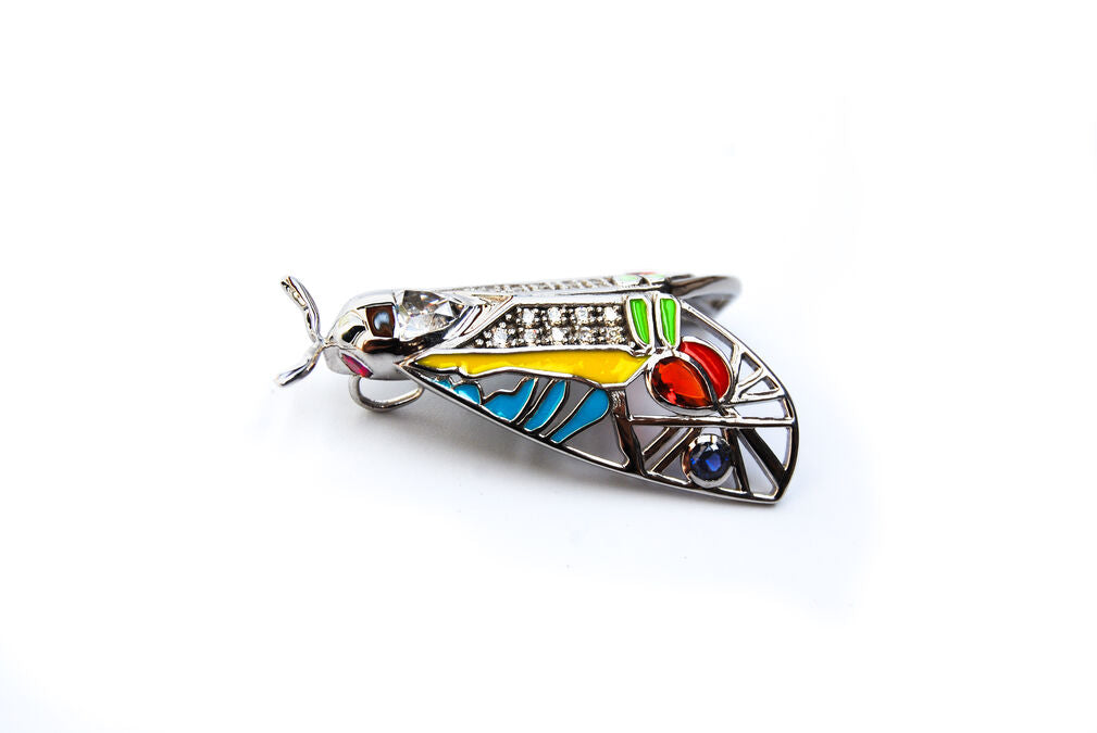 Side view of Picasso Moth pendant showcasing enamel detailing and zirconia stones on white background