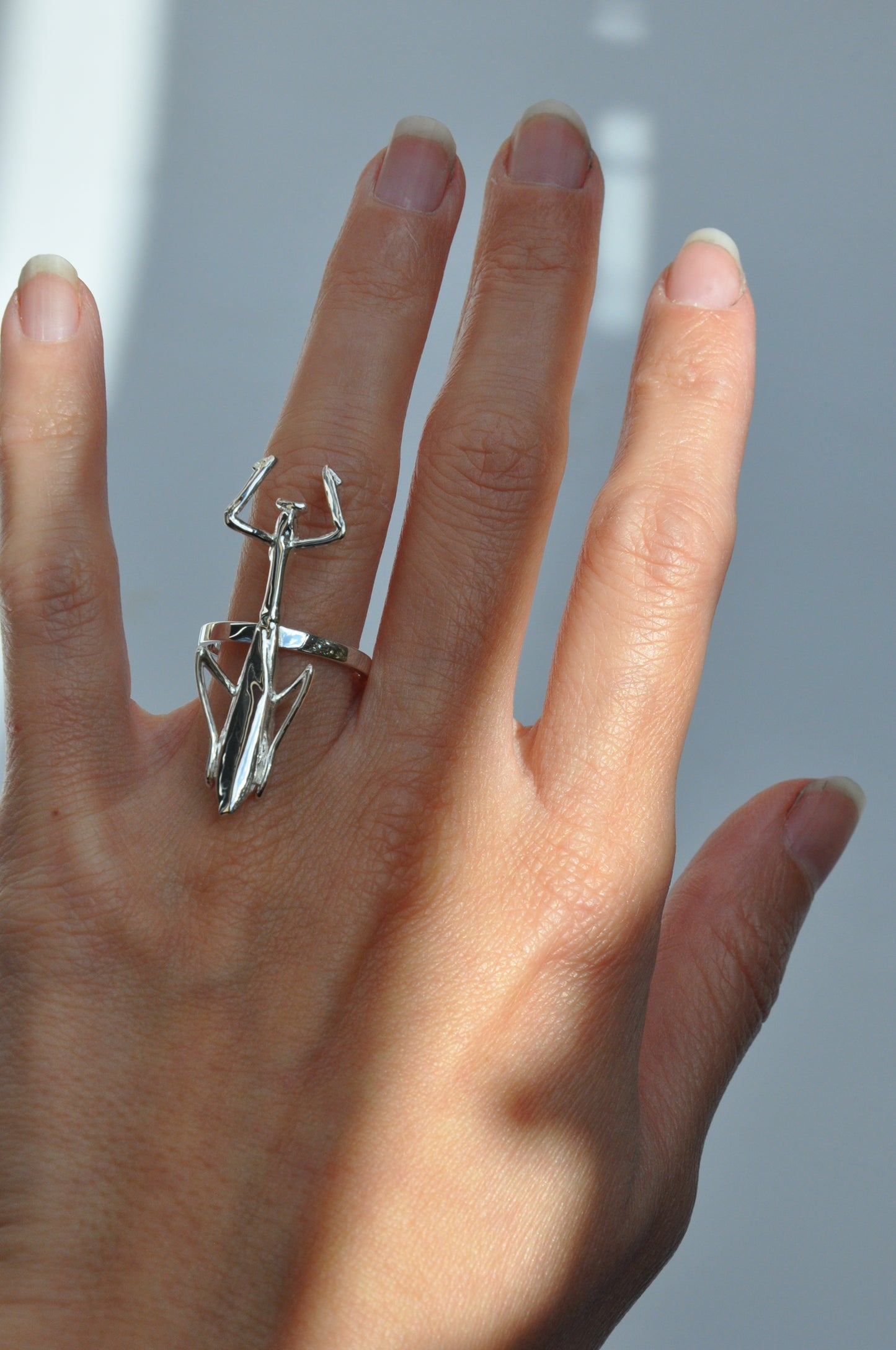 Sterling silver praying mantis ring featuring sculpted wings without the torso, nature-inspired insect jewelry design.