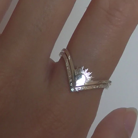 Video of celestial ring stack featuring sun, moon, and moth rings in mixed metals, worn on hand.