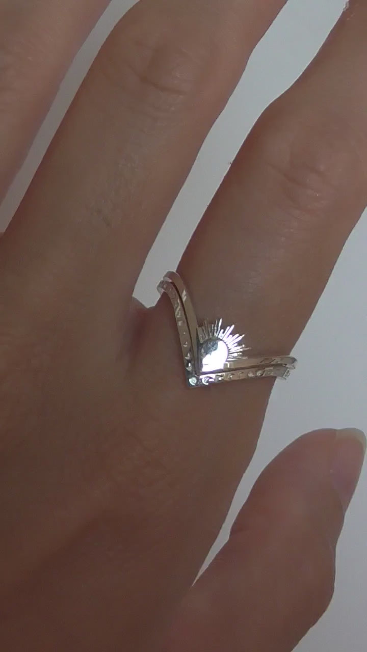 Video of celestial ring stack featuring sun, moon, and moth rings in mixed metals, worn on hand.