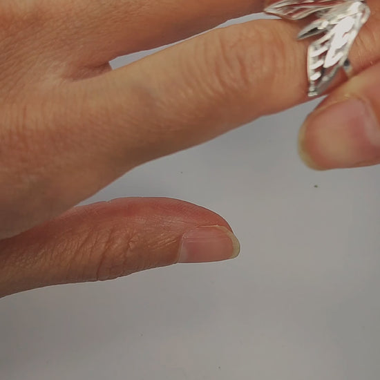 Model wearing silver and gold Sphinx Moth Rings, showcasing insect-inspired jewelry.