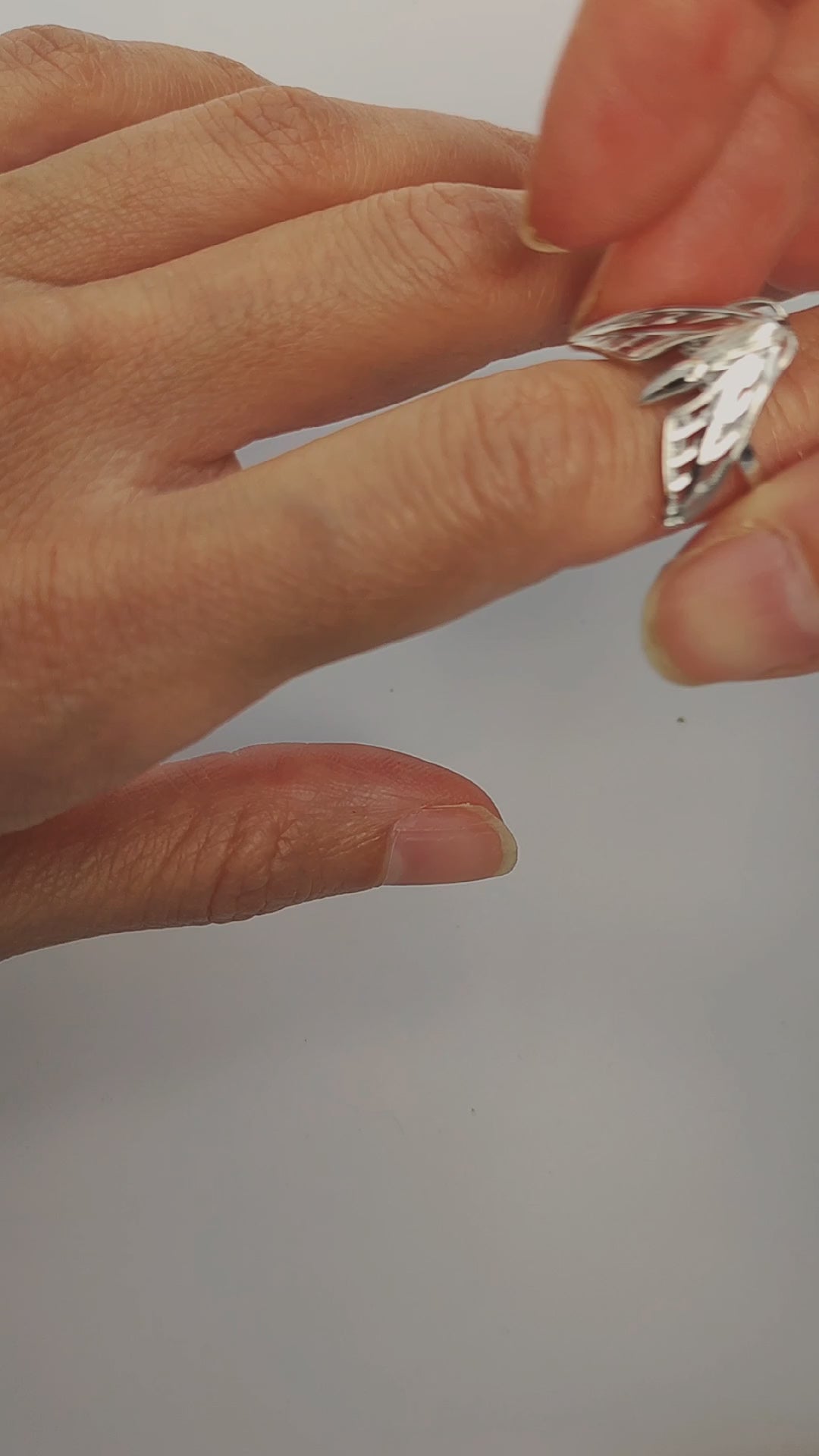 Model wearing silver and gold Sphinx Moth Rings, showcasing insect-inspired jewelry.