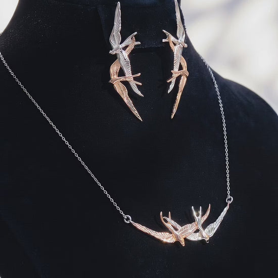 Video preview showing Swallow Flight Stud Earrings paired with matching necklace, capturing polished surfaces and sculptural symmetry.