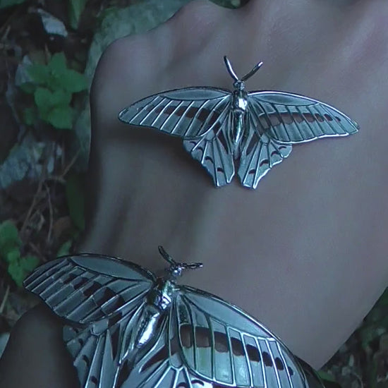Video of Blue Triangle Butterfly pendant and bracelet set, highlighting handmade details and shimmering silver finish.