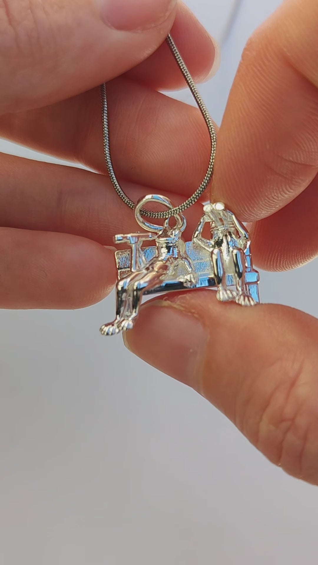 Video showcase of the Stargazer Frogs Pendant, featuring two miniature frogs — one with binoculars and one with a single‑lens viewer — gazing upward in a sculptural scene of quiet wonder.