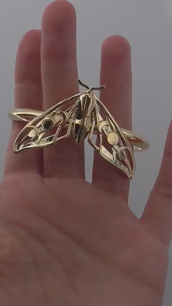 Video of Celestial Hawk Moth Bracelet in 14K gold plated finish, showcasing polished wings and moon phase details.
