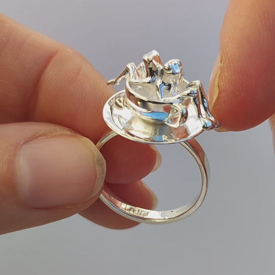 Video showcase of the Spinning Teacup Frogs Carousel Ring, featuring two miniature frogs seated inside a rotating sterling‑silver teacup and saucer, creating a kinetic carousel‑style scene.