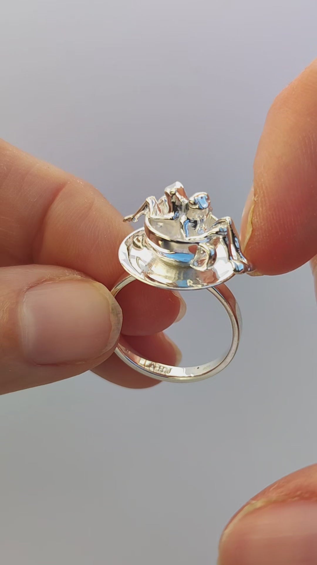 Video showcase of the Spinning Teacup Frogs Carousel Ring, featuring two miniature frogs seated inside a rotating sterling‑silver teacup and saucer, creating a kinetic carousel‑style scene.