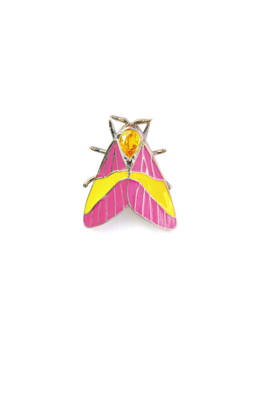 Rosy Maple Moth pendant in sterling silver with pink and yellow enamel wings, blue gemstone eyes, and yellow pear-shaped crystal on white background