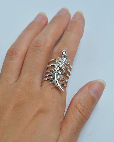 Full set of silver centipede stacking rings worn on a hand, highlighting the segmented design and metallic shine.