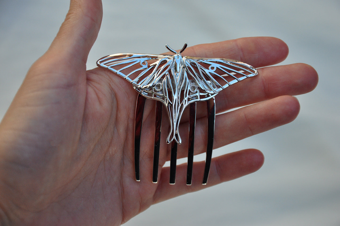 Front view of silver Luna Moth hair comb showcasing detailed wing cutouts and elegant insect-inspired design, handcrafted as nature-themed hair jewelry.