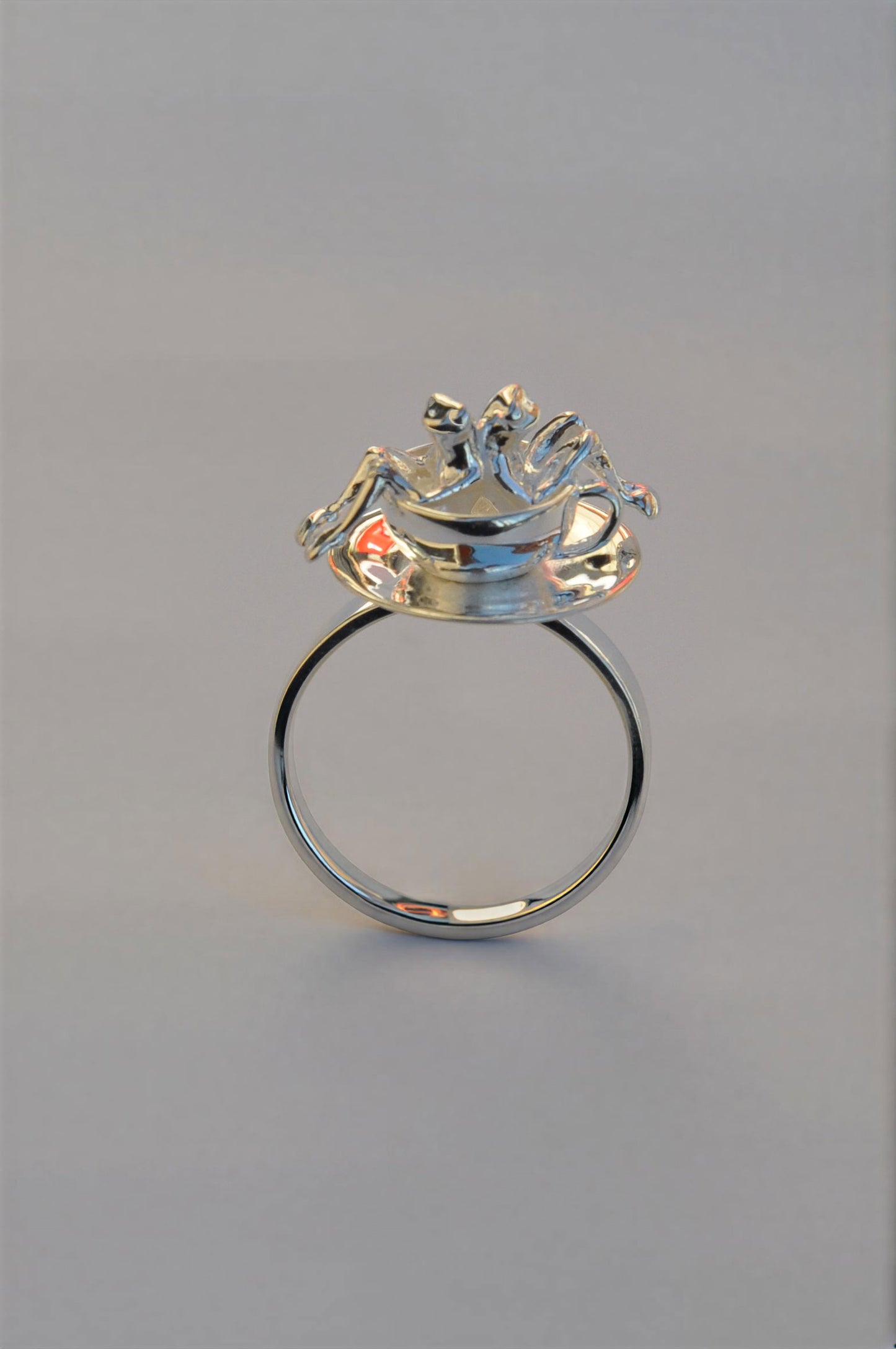 Spinning Teacup Frogs Carousel Ring featuring two tiny sculpted frogs seated inside a sterling‑silver teacup on a rotating saucer