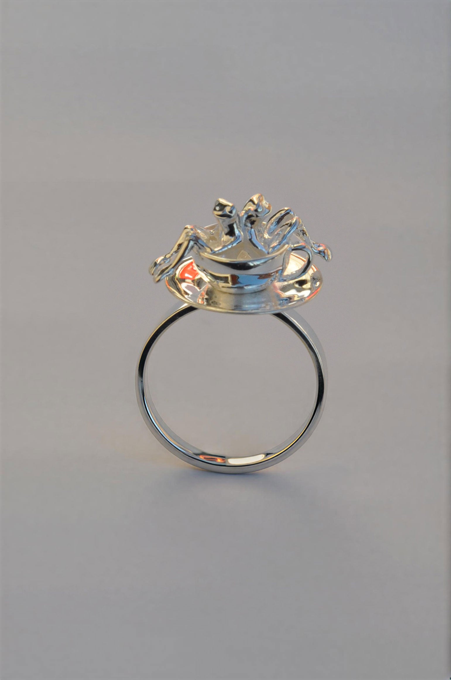 Spinning Teacup Frogs Carousel Ring featuring two tiny sculpted frogs seated inside a sterling‑silver teacup on a rotating saucer