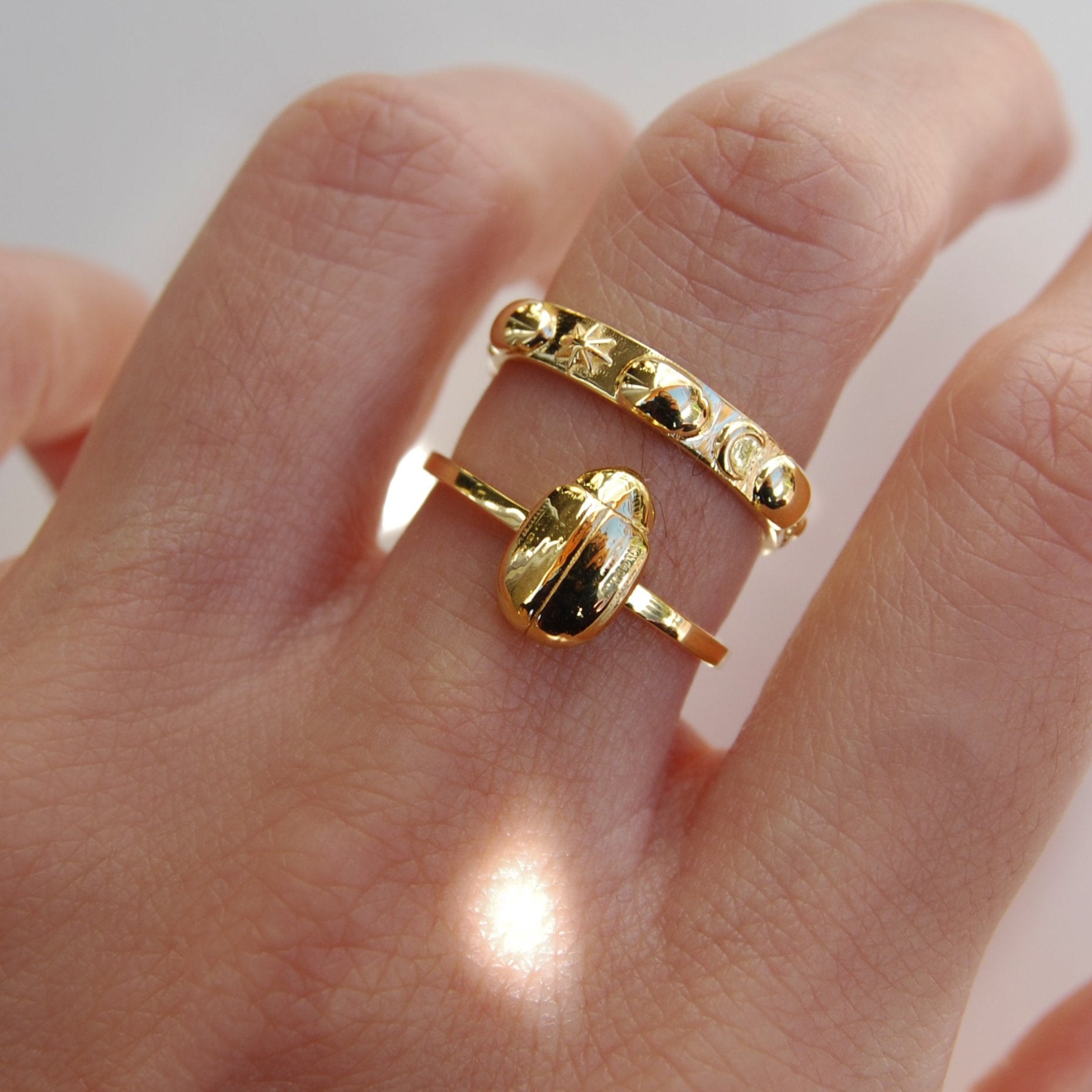Stacking beetle and celestial infinity ring featuring tiny scarabs and moon phase symbols, handcrafted for insect jewelry lovers.