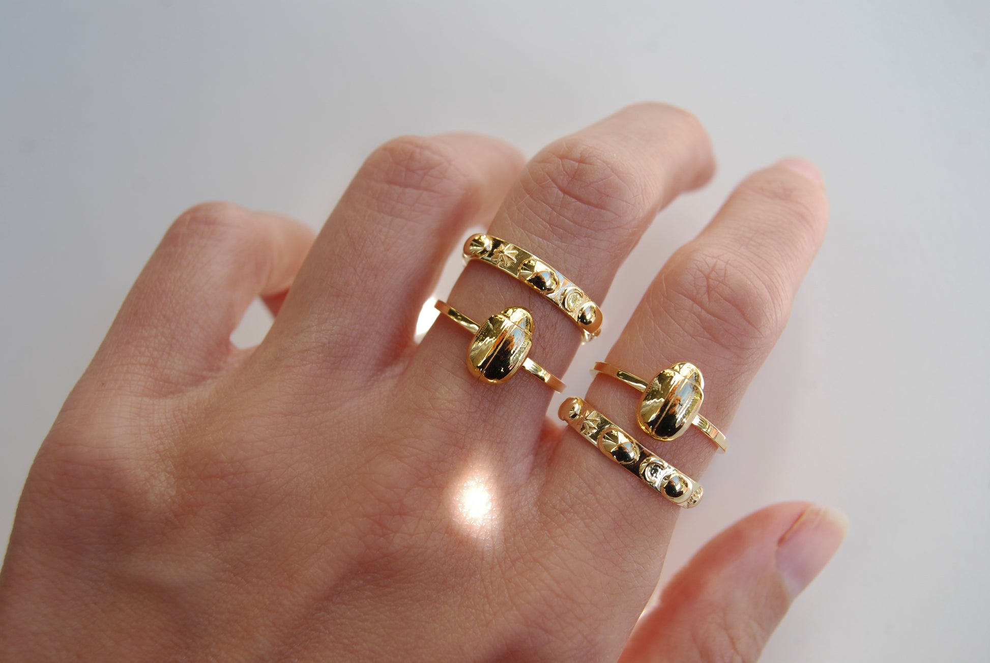 Celestial infinity scarab ring with miniature scarabs and cosmic motifs, a symbolic piece of bug jewelry.