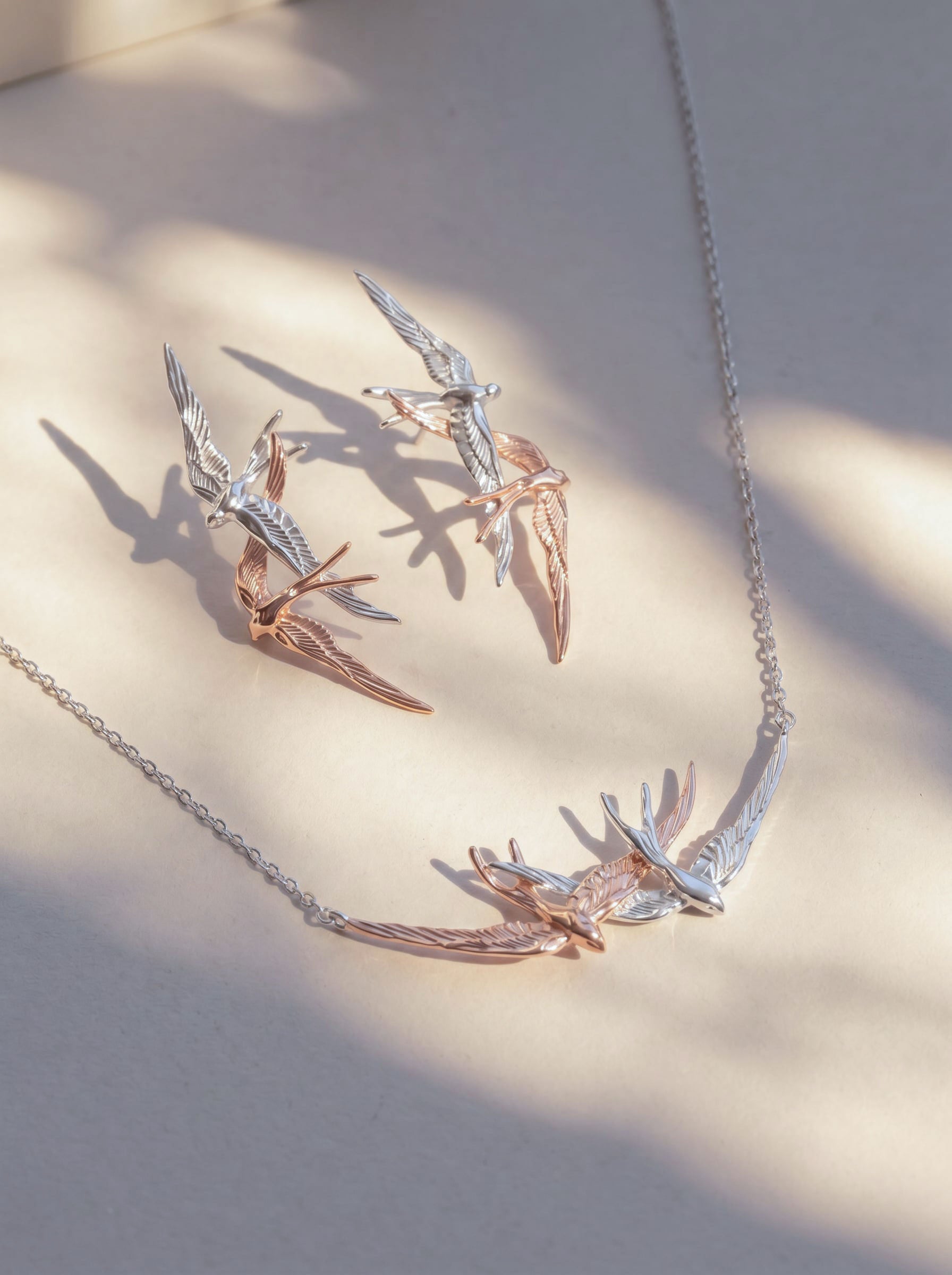 Swallow Flight Stud Earrings and matching necklace photographed together, emphasizing sculptural harmony and Art Nouveau inspiration.