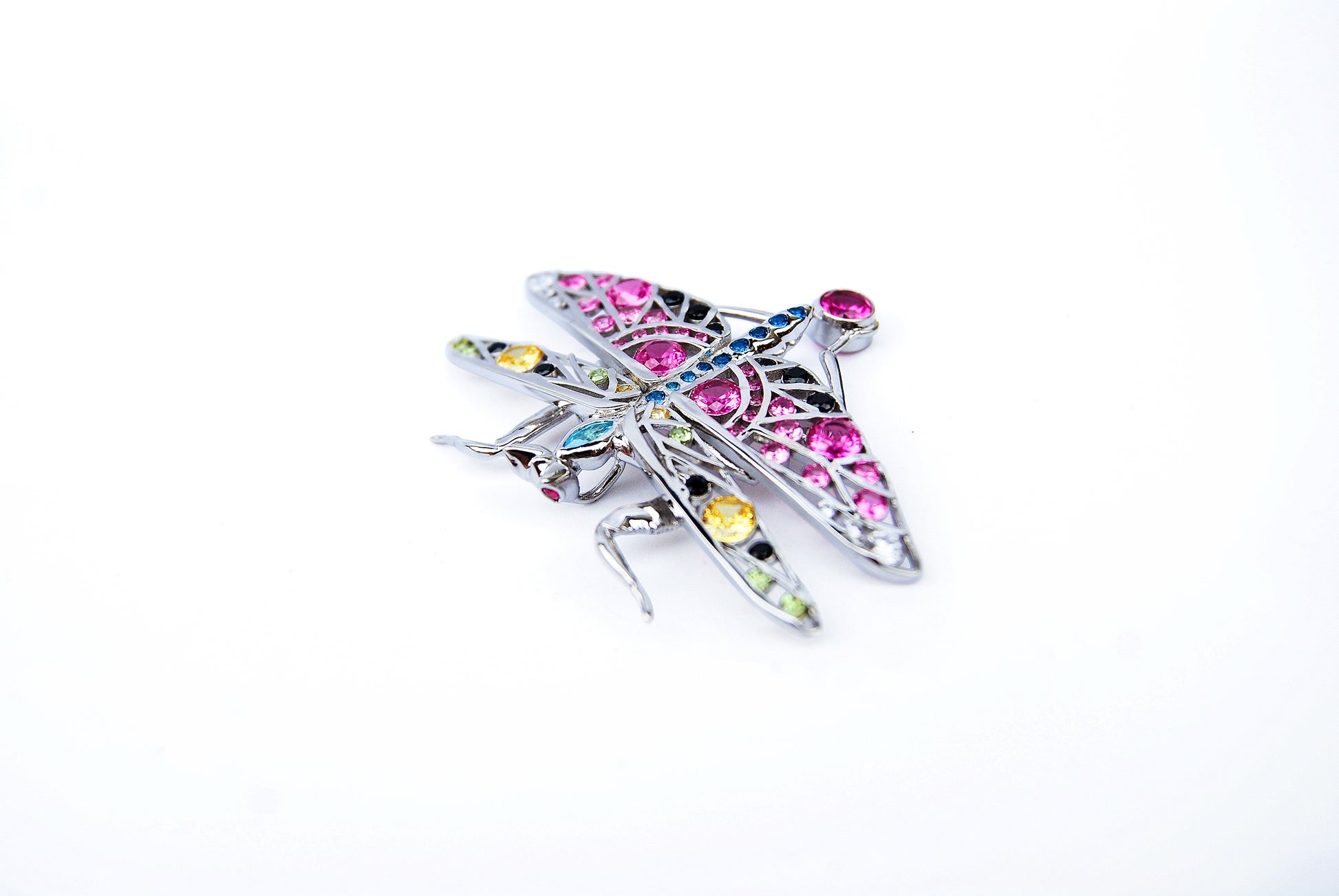Top view of silver praying mantis pendant on white background showing detailed limbs and polished surface