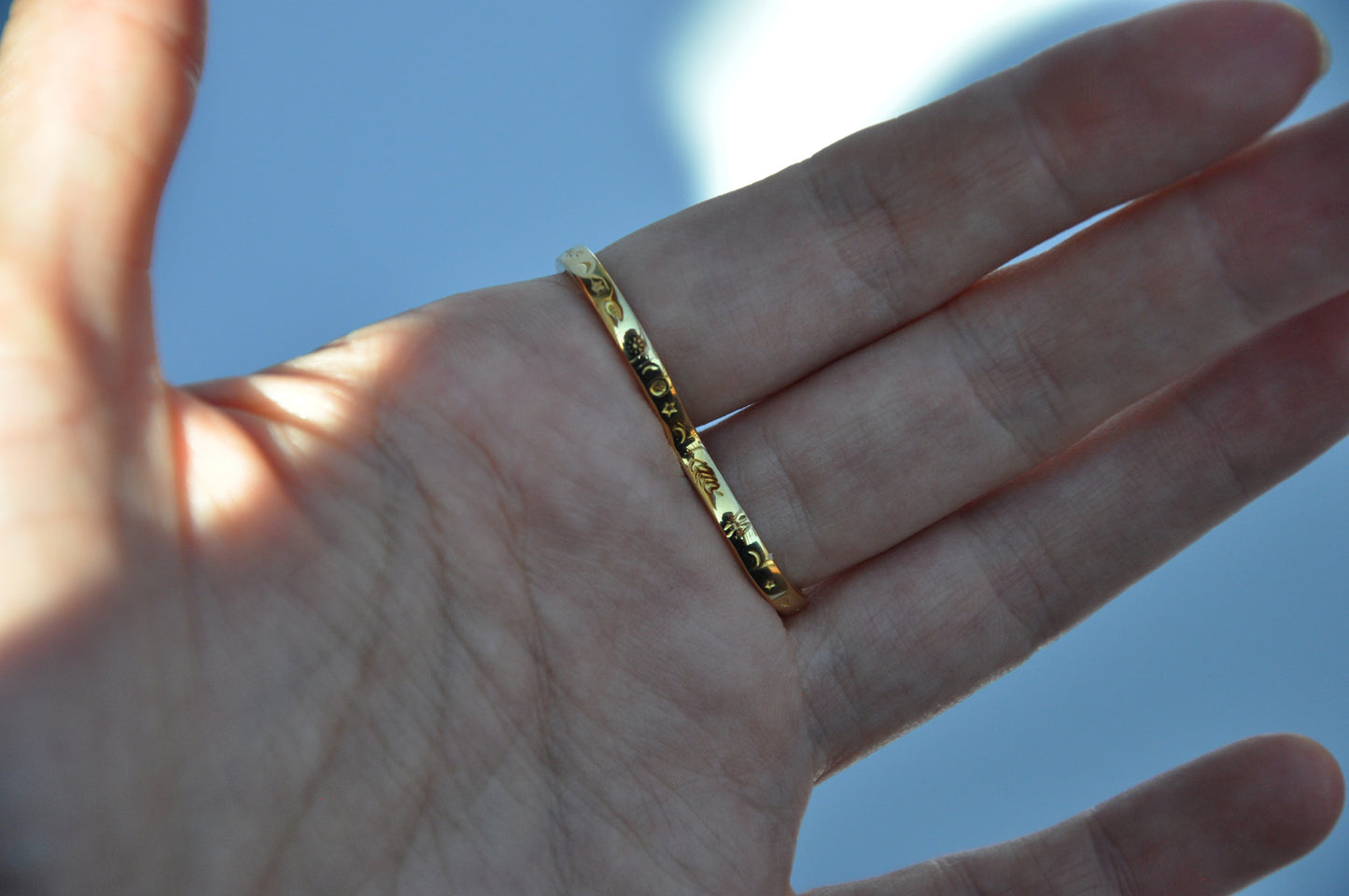 Back view of celestial snake ring in 14K gold plated finish on white background, showing wrap-around design.