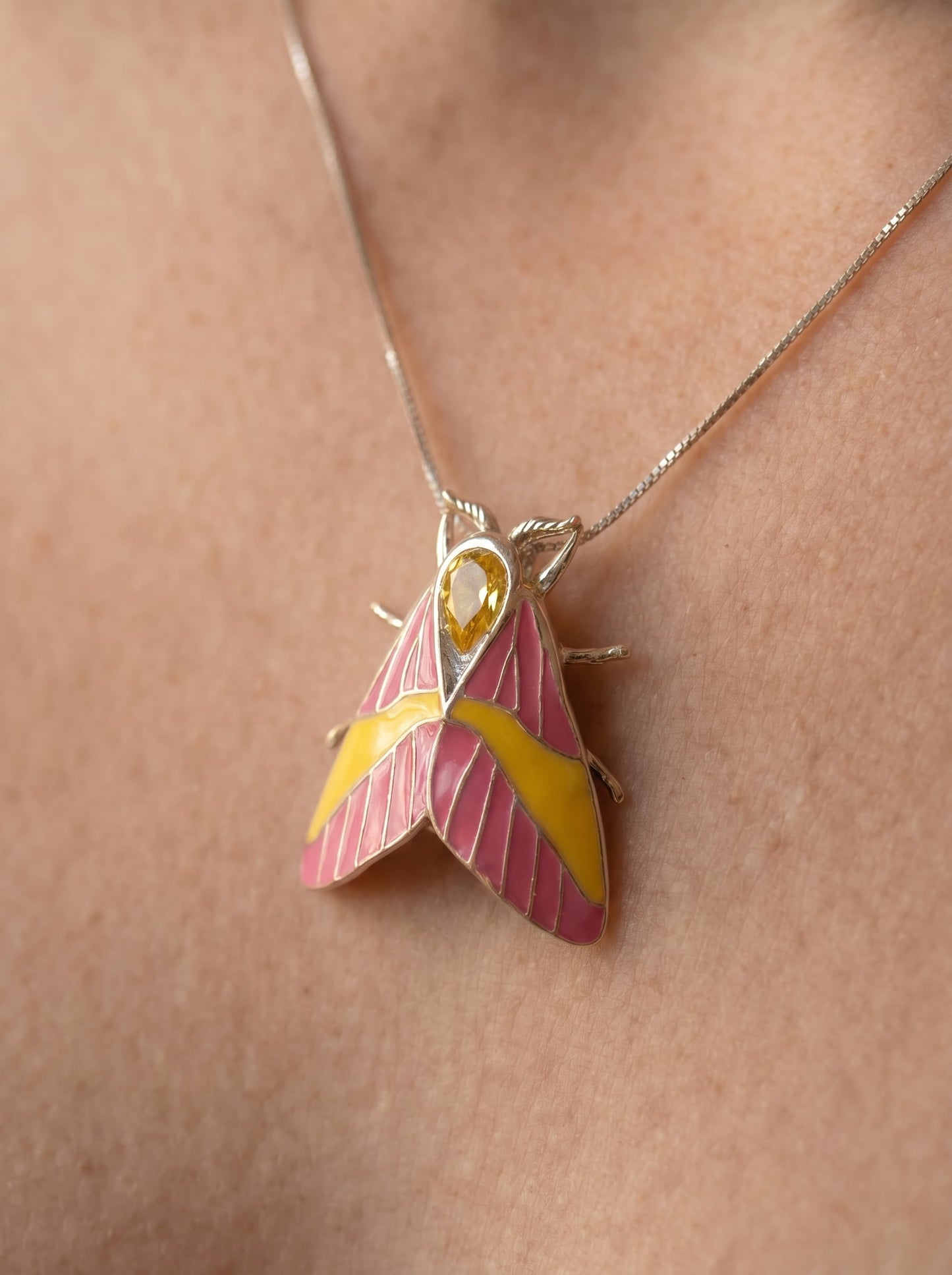 Rosy Maple Moth Pendant – Enamel Wings, Blue Gem Eyes & Yellow Crystal Accent