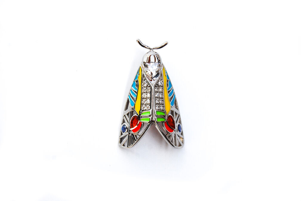 Zoomed-out view of Picasso Moth pendant with colorful enamel and zirconia stones on white background